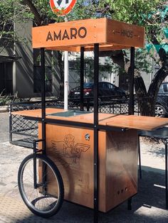 an outdoor food cart with a bicycle parked next to it