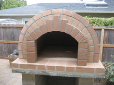 an outdoor brick pizza oven in the backyard