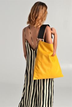 Akathi mat bag in yellow. A beautiful large hobo bag which is ideal for every day use. Not just a shoulder bag, a statetment tote which can easily be used as a shopper bag, even as a beach bag. It's loose minimalistic look makes it modern and unique. Handmade in our studio from lux italian cow yellow leather and a premium cow leather for the strap in black. Big rectangular metal loops in gold or silver are used to connect the strap with the bag and a metal swivel clasp is added in the interior f Modern Yellow Shoulder Bag For On-the-go, Chic Yellow Shoulder Bucket Bag, Modern Yellow Bag For Errands, Yellow Top Handle Bucket Bag For Travel, Summer Leather Hobo Bag, Chic Yellow Top Handle Bucket Bag, Chic Yellow Bags With Double Handle, Chic Yellow Bag With Double Handle, Yellow Top Handle Shoulder Bag For Errands