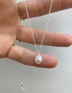 Beautiful and understated this necklace is timeless. D E T A I L S *It features an AA grade freshwater teardrop pearl with a lovely smooth and even nacre.  *Pearl measures around 8-8.5m *Choose between a 14k gold filled or 925 sterling silver chain.  *Necklace comes with an information card and is ready for gifting. C A R E * T I P To keep your necklace in good condition please avoid contact with water and remove when exercising or sleeping. Store away from heat, moisture and direct sunshine. T Simple Silver Jewelry With Pearl Charm, Simple Silver Pearl Drop Jewelry, White Gold Teardrop Pearl Necklace With Charm, Classic White Pearl Charm Necklaces, Everyday White Gold Pearl Drop Necklaces, Everyday White Gold Necklace With Pearl Drop, Everyday White Gold Pearl Drop Necklace, Delicate Sterling Silver Charm Necklace With Pearl Pendant, Dainty Silver Charm Necklace With Pearl Drop