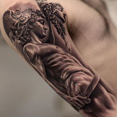 a man's arm with an angel tattoo on it