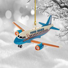 an airplane ornament hanging from a tree