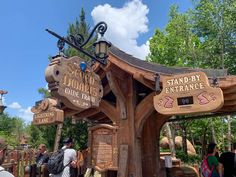 several people are standing in front of the entrance to disneyland's animal kingdom attraction