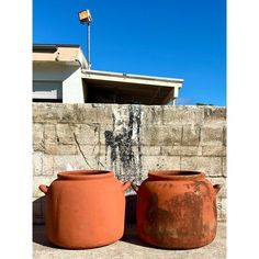 two large clay pots sitting next to each other