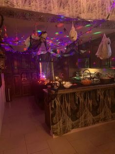 an elaborately decorated kitchen is lit up with purple and green lights, hanging from the ceiling