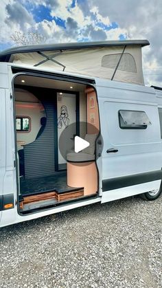 an rv with its door open and the interior opened to show it's storage area