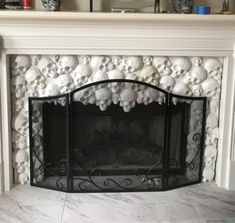 a fireplace with skulls on the mantle