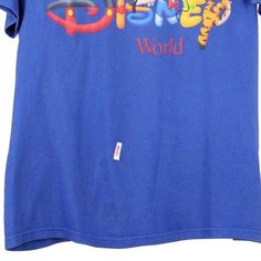 Description:Vintage Disney World blue Mickey Inc t-shirt, fits medium.GENDER: mens CONDITION: good - mark on front.STYLE: t-shirtERA: 1990sCOLOUR: blueFABRIC: cotton Blue T-shirt With Character Print For Streetwear, Blue Graphic Tee For Disney Fan Events, Blue Graphic Print T-shirt For Disney Fan Events, Vintage T-shirt With Letter Print For Disney Fans, Vintage T-shirt With Graphic Print For Disney Fan Events, 90s Blue Logo Print T-shirt, 90s Blue Short Sleeve T-shirt, 90s Style Blue Short Sleeve T-shirt, Shirt Fits