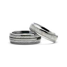 two white gold wedding bands with diamonds on each side and inlays to the sides