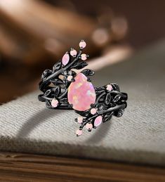 Unique Pear Pink Fire Opal Engagement ring Set Gothic Art deco Black Gold Cluster Vine Leaf Wedding Band Vintage Stacking Bridal Promise Set Applicable scene: anniversary, birthday party, wedding, engagement, gift ■ Handmade, high-quality item! ■ Material: S925 Sliver SOLID 14K/18K BLACK GOLD (can be made in white/rose/yellow gold) Engagement ring ■ Center stone: Pink Opal ■ Size/Weight: 6*8mm pear ■ Side stones: Pink Opal ■ Total weight: 0.042 ct (High Quality) ■ Cut - VG ■ Color: G-H ■ Clarity Black Diamond Wedding Rings Flower, Opal Engagement Ring Black Band, Luxury Gemstone Promise Wedding And Engagement, Opal Wedding Ring Black Band, Unique Engagement Rings Black Opal And Silver, Unique Purple Engagement Rings, Black And Pink Wedding Rings, Engagement Rings Gothic, Ethereal Wedding Rings