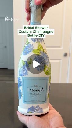 a person holding a bottle of wine in their hand with the caption bridal shower custom champagne bottle dispenser