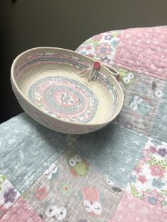 a bowl sitting on top of a quilted table cloth