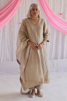 Pearl beige kurta with embroidered neckline and border hem. Comes with cigarette pant.
Component: 2
Pattern: Plain
Neckline: V-Neck
Sleeve Type: Three Quarter
Fabric: Handloom Tissue, Lining: Shantoon
Color: Beige
Other Details: 
Hand embroidered lace trims
Side slit kurta
Side pocket pant
Note: The dupatta worn by the model is not for sale
Occasion: Puja - Aza Fashions Tissue Kurta, Beige Kurta, Kurta Designs Women, Embroidered Neckline, Net Dupatta, Kurta With Pants, Fashion App, Kurta Designs, Pant Set