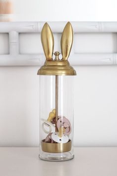 a glass jar filled with gold colored items