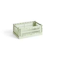 a green crate sitting on top of a white surface