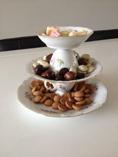 two plates stacked on top of each other with food in the middle one plate is filled with cookies and candy