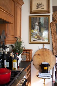 a kitchen with wooden cabinets and pictures on the wall