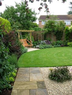 a garden with grass, rocks and plants