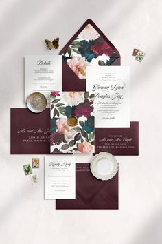 the wedding stationery is laid out on top of each other