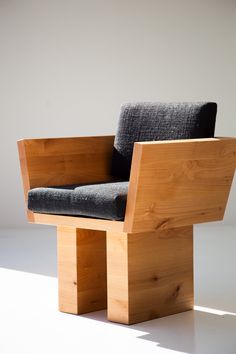 a chair made out of wood sitting on top of a white floor next to a wall