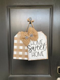 a door hanger that says home sweet home with a burlock bow on it