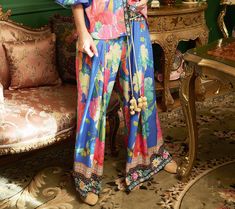 Embrace the effortless charm of these feminine pants, where comfort meets a burst of floral elegance. These pants feature a captivating floral print, enhanced by a contrast border print at the waistband and hem, making every day feel like a stroll through a blooming garden. From Aratta. Bohemian Floral Print Pants For Loungewear, Floral Print Wide-leg Loungewear Pants, Floral Print Loungewear Ankle-length Pants, Feminine Pants, Blooming Garden, Border Print, Feel Like, Royal Blue, Every Day