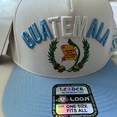 Cap With Guatemala Embroidered On The Front Casual White Embroidered Snapback Hat, White Embroidered Cotton Baseball Cap, White Embroidered Cotton Snapback Hat, Casual White Snapback Hat With Embroidered Patch, White Embroidered Flat Bill Baseball Cap, White Embroidered Flat Bill Hat, Guatemala, One Size Fits All, Full Service