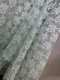 the curtain is closed and has white flowers on it