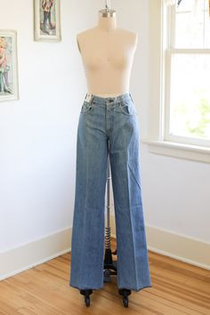 Rare 1970s old-store stock 100% cotton denim flares in a range of killer medium wash blues.  Belt loops, marigold top stitching, copper rivets and lightning bolt branded button. Leather branded rear patch. Front metal Scovill zipper. Lower rise. These flared legs make your legs look longlonglong. Hems are serged and were intended to be cuffed as shown on model or hemmed to suit the new owner perfectly. Model shown is a size 2 and is about 5'7" in flat shoes. The extra long inseams are also great Retro Mid-rise Cotton Flare Jeans, Retro High Waist Light Wash Flare Jeans, Retro Flare Cotton Jeans, Light Wash High Rise Retro Flare Jeans, Retro High Rise Light Wash Flare Jeans, Vintage Faded Pants, Retro Light Wash Cotton Flare Jeans, Vintage High Waist Cotton Flare Jeans, Denim Blue Retro Full Length Flare Jeans