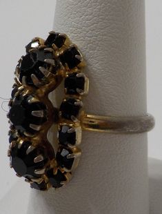 "Vintage faux black onyx ring. Setting is 1/2\" x 1\" loaded with faceted, & prong set faux black onyx. All are present and intact. Adjustable band is currently set at size 8...some discoloring at the bottom of the band. See last picture. Excellent vintage condition." Vintage Black Rings For Jewelry Making, Black Oval Jewelry For Party, Black Diamond Rings For Evening, Adjustable Black Rings For Party, Adjustable Black Party Rings, Adjustable Black Party Ring, Black Stone Jewelry For Party, Black Oval Jewelry For Evening, Black Victorian Rings With Black Enamel