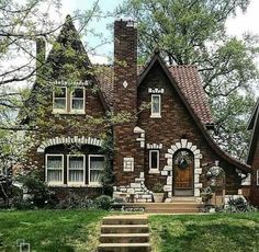 a small brick house with steps leading up to the front door and windows on each side