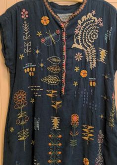 an embroidered shirt hanging on the wall