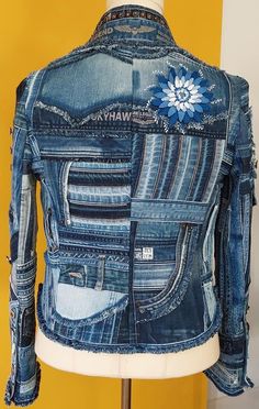 the back of a jean jacket with flowers on it