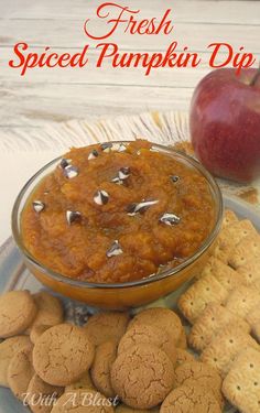 a plate with cookies, crackers and an apple on it