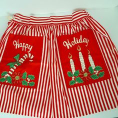 a pair of red and white striped shorts with holiday decorations