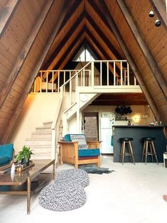 a living room filled with furniture under a roof