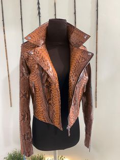 Woman's Python Leather Biker Jacket  PREMIUM QUALITY LUXURY STYLE Outside: Snakeskin  Accessories: golden color (please see the photo). All our products are 100% handmade, we always try to create interesting ideas to make your style unique. We use only the highest quality materials and accessories from around the world and only best leather from Indonesia. Before listing each new model undergoes different quality and usability tests at every stage of production. Every single piece is made by han Luxury Brown Biker Jacket With Zipper Closure, Luxury Brown Biker Jacket With Zipper, Designer Brown Leather Jacket With Zipper, Designer Brown Leather Jacket With Zipper Closure, Luxury Brown Long Sleeve Biker Jacket, Designer Brown Biker Jacket For Fall, Luxury Fitted Brown Biker Jacket, Luxury Brown Biker Jacket, Designer Fitted Brown Biker Jacket