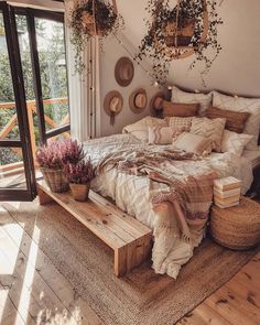 a bed sitting on top of a wooden floor next to a window