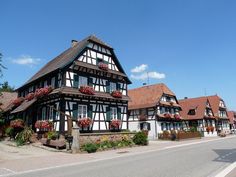 a row of houses with flower boxes on the roof