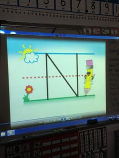 a computer screen with a cartoon character on it's display in front of a classroom wall