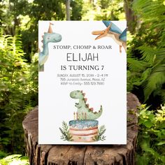 a dinosaur birthday party sign sitting on top of a tree stump