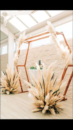 two tall white vases sitting on top of a wooden floor