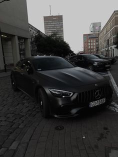 a black car parked on the side of a road