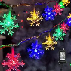 christmas lights are hanging from the ceiling in front of a fire hydrant and decorated with snowflakes