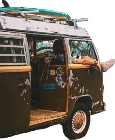 a man laying on the back of a van with his surfboard strapped to it