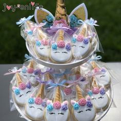 there are many decorated cookies in the shape of unicorns on this cake platter