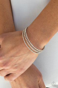 Two strands of dazzling white rhinestones flank a row of shiny silver beads, coalescing into a sparkly layered cuff around the wrist.

 Sold as one individual bracelet. Paparazzi Jewelry Images, Sparkly Fashion, Paparazzi Accessories Jewelry, Candy Bracelet, White Bracelets, Ball Necklace, Paparazzi Accessories, Blue Gems, White Rhinestone