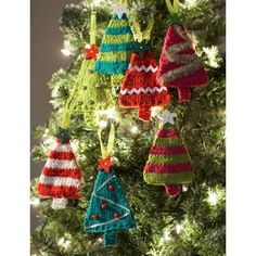 crocheted christmas ornaments hanging from a tree