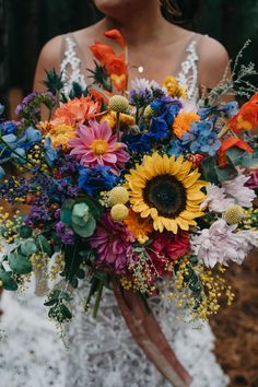 a woman holding a bouquet of flowers in her hands