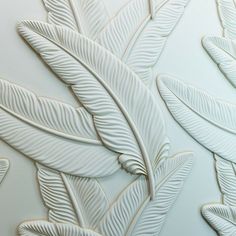 an artistic wallpaper with white leaves on it's side and the bottom part of its design